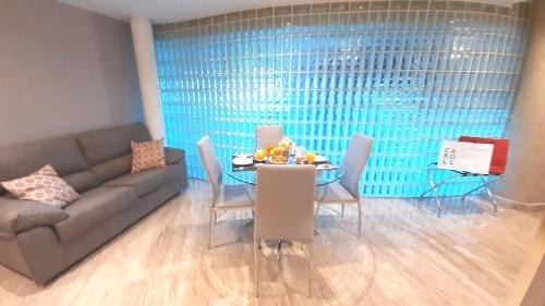 a living room with a couch and a table with chairs at Hotel Nueva Plaza in Maliaño
