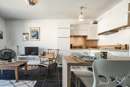 a kitchen and living room with a table and chairs at CABANA & Le Manoir - Proche du Lac in Annecy