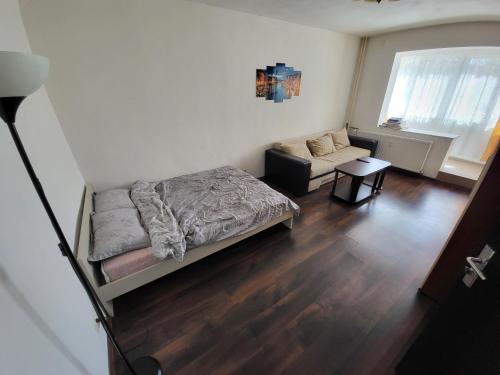 a small bedroom with a bed and a couch at Studio in Bucharest