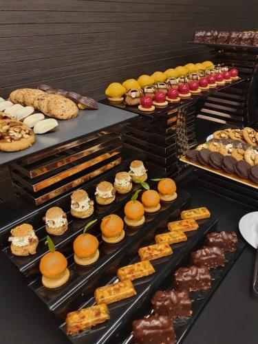 a buffet line with different types of pastries and desserts at Jaal Riad Resort in Marrakech