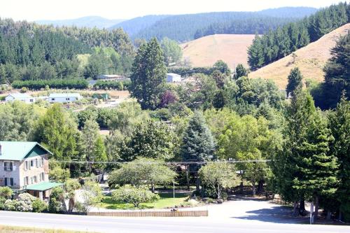 an aerial view of a town with trees and a house at The Mill House in Herbert