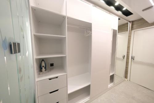 a bathroom with white cabinets and a shower at Sky Garden Suites in Adana