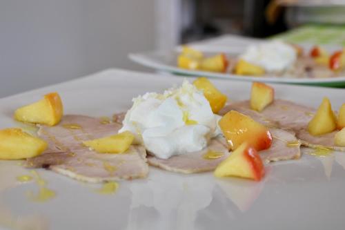 a plate of food with ice cream and fruit on it at Agriturismo Oasi Biologica in Montedinove