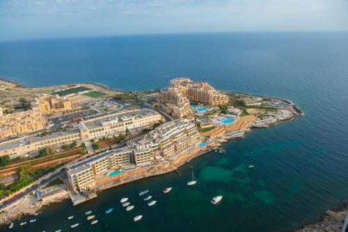 an aerial view of a resort near the water at Marina Hotel Corinthia Beach Resort Malta in St Julian's