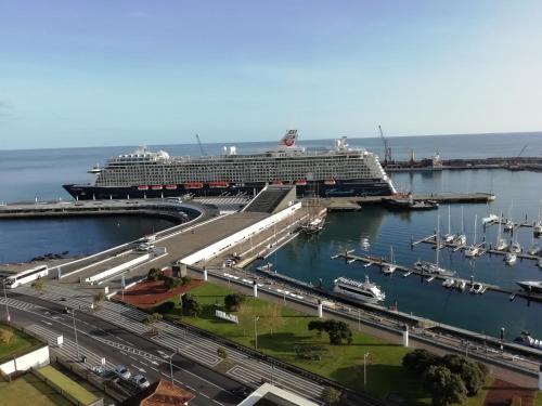 a cruise ship is docked at a harbor at SolMar View Apartment, Azores in Ponta Delgada
