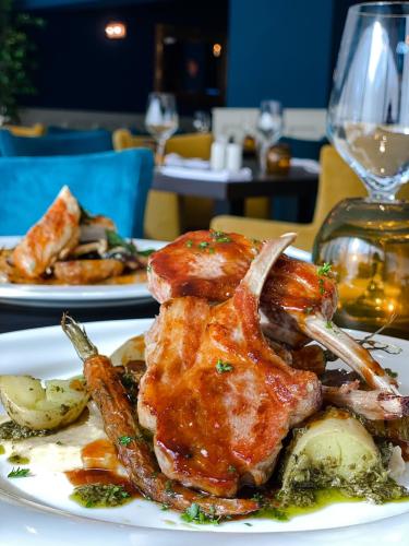 a plate of food with meat and potatoes on a table at South Sands Hotel in Weston-super-Mare