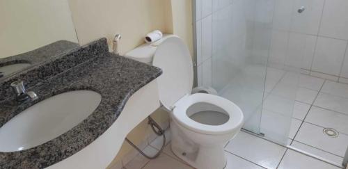 a bathroom with a toilet and a sink and a shower at Thermas Place in Caldas Novas