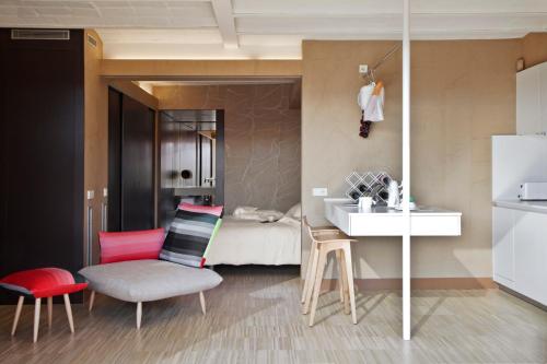 a bathroom with a sink and a bedroom with a bed at DestinationBCN Universitat Apartments in Barcelona