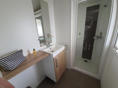 une salle de bain avec un lavabo et une douche dans l'établissement Camping la Plage, à Saint-Hilaire-de-Riez