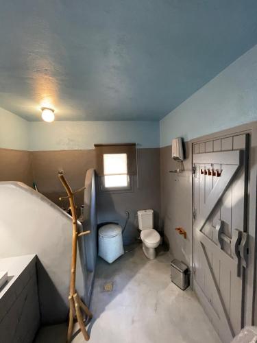 a small bathroom with a toilet and a sink at Waterfront villa "Afros" with a pool, direct access to the sea and a small beach in Koundouros