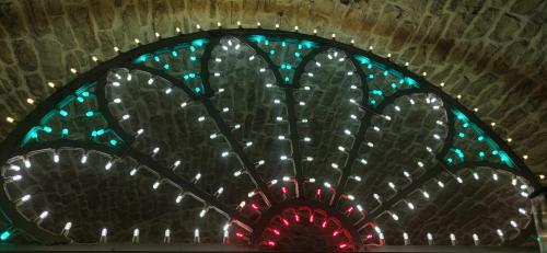 a stained glass window with green and blue lights at PIETRAVIVA Housing in Molfetta