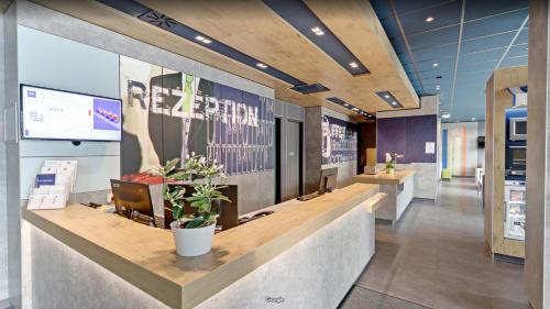 a lobby of an office with a reception desk at ibis budget Berlin Alexanderplatz in Berlin