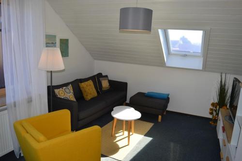 a living room with a couch and a chair at Ferienwohnung Alb-Traum in Erkenbrechtsweiler