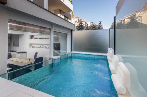 an infinity pool with a slide in a house at Luxury apartment Martinis with pool in Split
