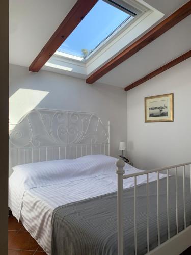 a bedroom with a bed with a skylight at Seaside apartments Petar in Krk