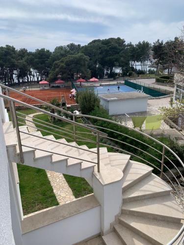 a set of stairs leading to a swimming pool at Seaside apartments Petar in Krk