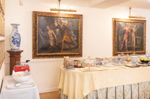 a dining room with a table with a painting on the wall at Hotel Due Mori in Cittadella