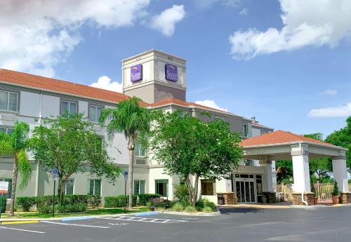 a building with a clock tower on top of it at Sleep Inn & Suites Ocala in Marion Oaks
