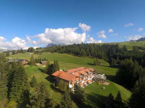 an aerial view of a large house on a green field at Ferienparadies Sabina Birke in Alpe di Siusi