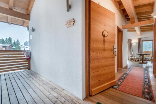 a wooden door in a room with a porch at Ferienparadies Sabina Birke in Alpe di Siusi