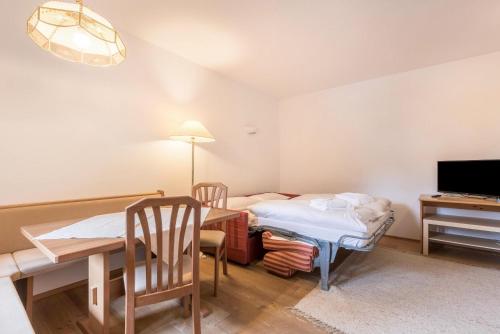 a living room with a table and a dining room at Ferienparadies Sabina Spitzbühl in Alpe di Siusi