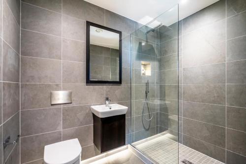 a bathroom with a shower and a toilet and a sink at The Castle Suite @ Ryedale House in York
