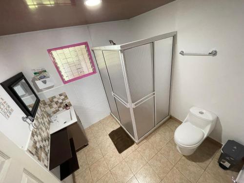 a bathroom with a shower and a toilet and a sink at Finca El Arrullo in Puerto Espejo