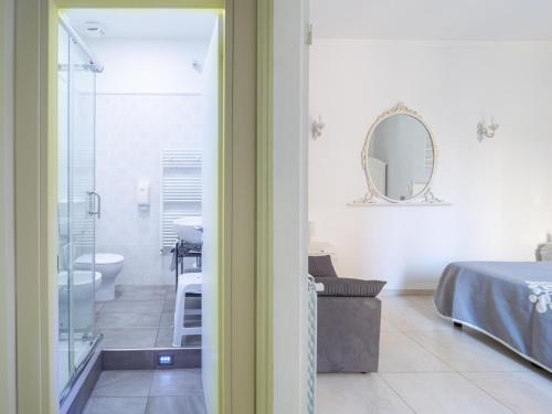 a bathroom with a bed and a shower and a sink at Affittacamere Golfo Della Luna in La Spezia