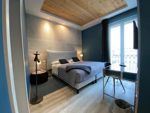 a bedroom with a bed and a desk and a window at Residenze Romano Ristorante & SPA albergo diffuso - WHITE in Foggia