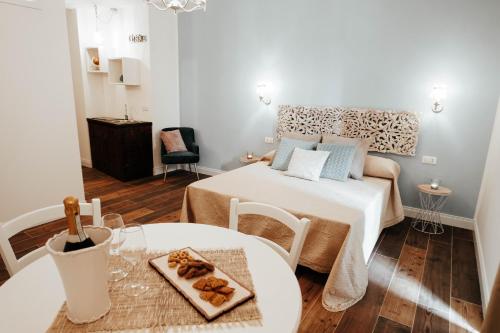 a small room with a bed and a table at ALMASOL - Charme Experience in Castellana Grotte