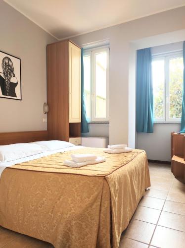 a bedroom with a bed with two towels on it at Hotel Nuovo Rondò in Sesto San Giovanni