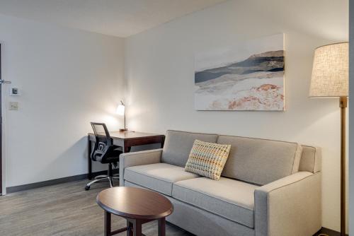 a living room with a couch and a desk at MySuites Lawton in Lawton