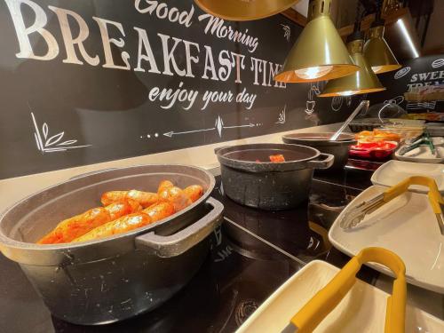 a kitchen with two pans of food on a counter at Hex Wildlife Hotel at Yorkshire Wildlife Park in Doncaster