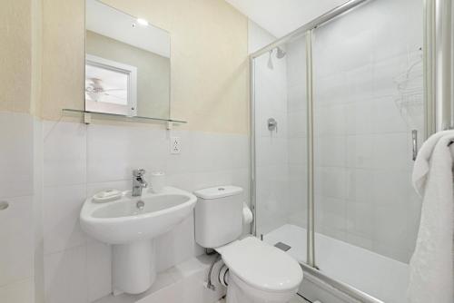 a bathroom with a toilet and a sink and a shower at Lantana 42 in Saint James