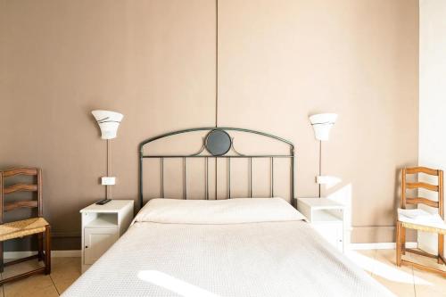 a bedroom with a bed with two night stands and two lamps at Stop & Sleep Bergamo in Bergamo