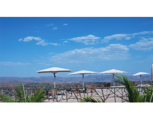 a group of white umbrellas on top of a beach at Gondar Hills Resort in Gonder