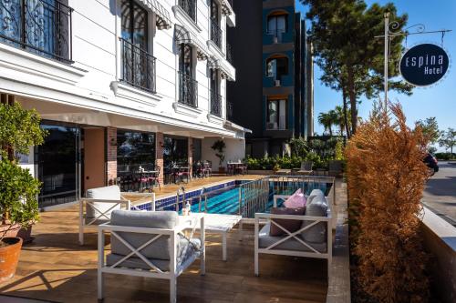 a hotel with a swimming pool in front of a building at Espina Hotel in Antalya