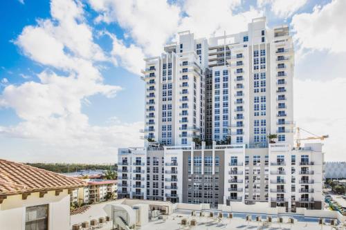 an image of a large white apartment building at Tucker at Palmer Dadeland Miami in Miami