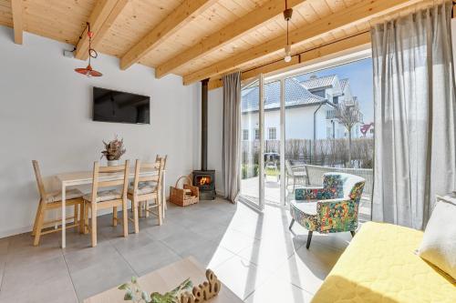 a living room with a table and chairs and a fireplace at Stodoły Nad Morzem by Downtown Apartments in Jastrzębia Góra