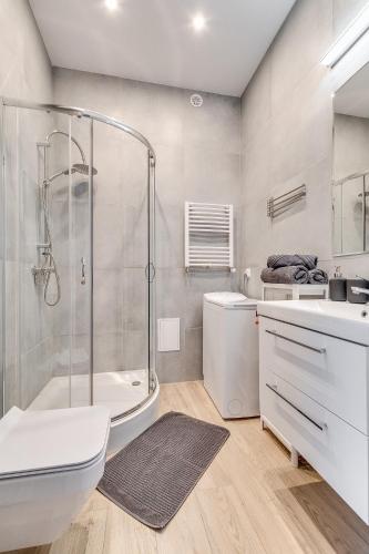 a bathroom with a shower and a toilet and a sink at Central Platinum Apartments 28 z balkonem in Rybnik