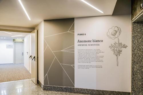 a wall with a sign in a hallway at Mercure Milano Agrate Brianza in Agrate Brianza