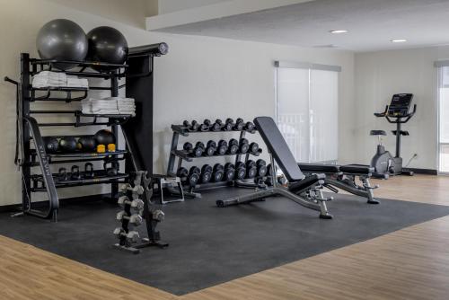 a gym with lots of exercise equipment in a room at MySuites Lawton in Lawton