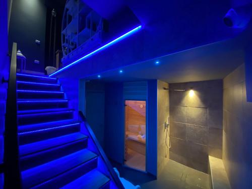 a staircase in a room with blue lights at Residenze Romano Ristorante & SPA albergo diffuso - WHITE in Foggia