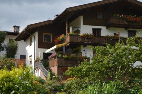 a house with flower boxes on its balconies at Ferienwohnung Garber in Uderns