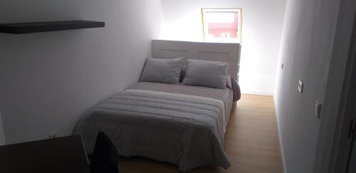 a small bedroom with a bed in a room at APARTAMeNTOS DON MANUEL A in Cee