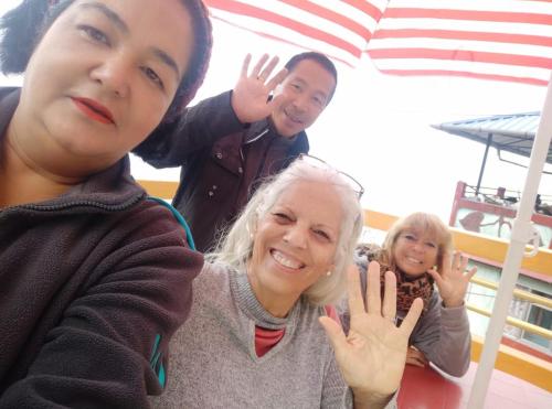 a group of people standing around a woman at Lotus Homestay in Darjeeling