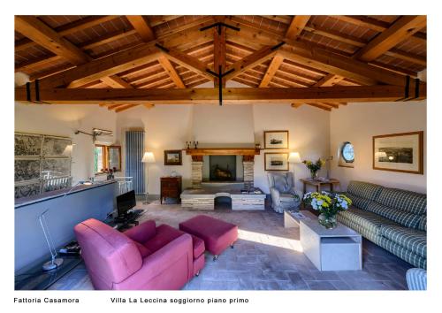 a living room with couches and a fireplace at Fattoria Casamora - Villa La Leccina in Pian di Scò