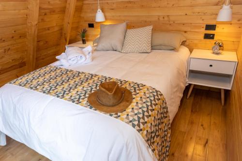 a bedroom with two beds with a hat on the bed at Hosteria Papagayo Cotopaxi in Machachi