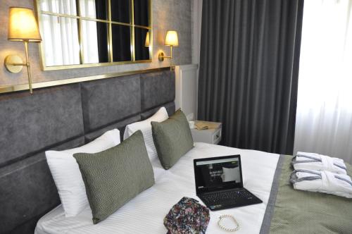 a laptop on a bed in a hotel room at CONNECT THERMAL HOTEL in Ankara