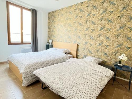 Ένα ή περισσότερα κρεβάτια σε δωμάτιο στο 702 Studio cosy à proximité de Paris 20ème